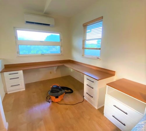 L-shaped desk with white shaker drawers and cherry veneer countertops.