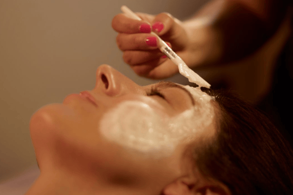 Woman receiving luxury Woodhouse facial treatment.