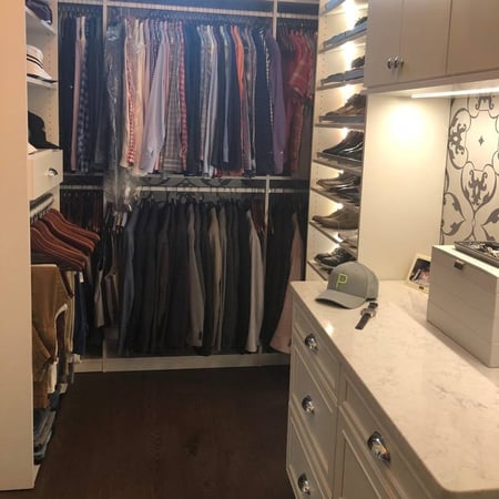 A walk-in closet designed with neatly organized clothing.