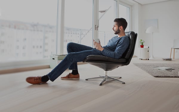 Man looking out the window and thinking about getting condo insurance