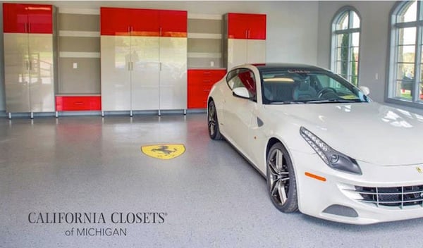Custom garage storage with acrylic doors and drawers and red accents.
