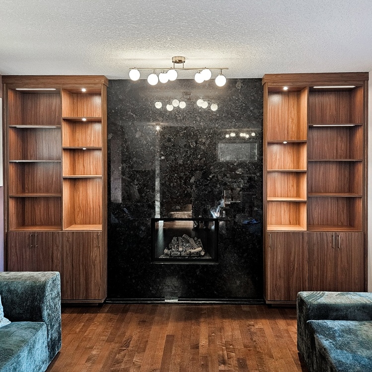 Living room shelving flanking either side of the fireplace with clean lines, open shelving, lighting, and lower cabinets.