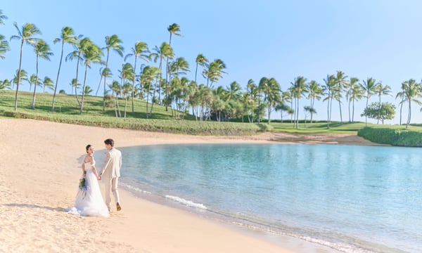 浜辺を歩く新郎新婦