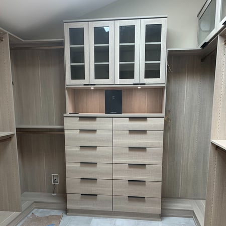 Tan walk-in closet shelves with organized clothes and accessories