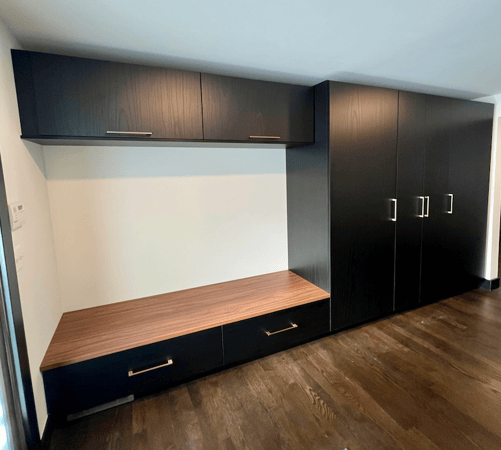 Custom mudroom storage with built-in bench, drawers, and cabinets