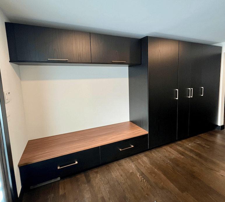 Custom mudroom storage with built-in bench, drawers, and cabinets