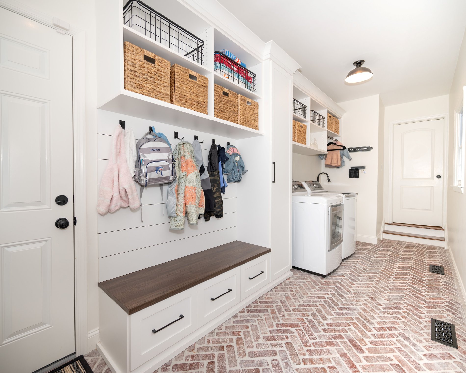 Mudroom with cabinets, bench, hooks, by California Closets Northern NJ.