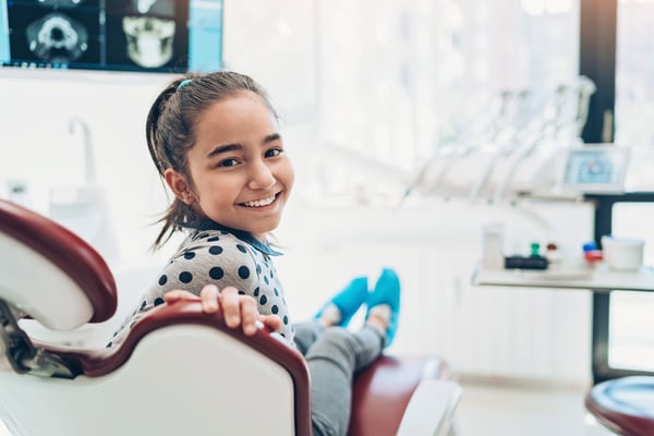 Young child smiling in dentist chair