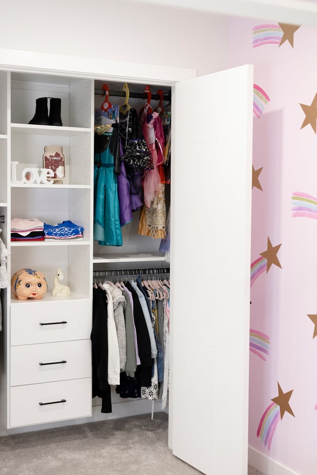 Girls closet with double hang, open shelves, and drawers.