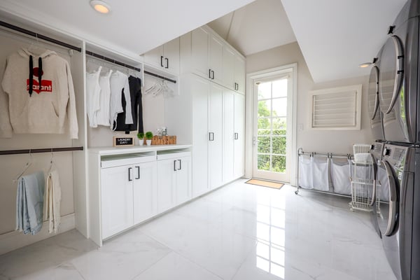 Custom laundry room with cabinets and hanging space by California Closets Miami, Florida.