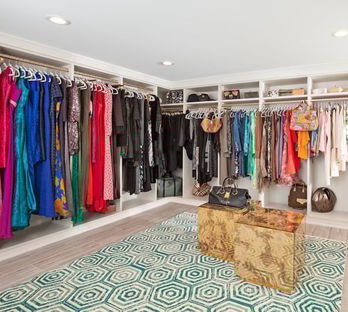 Large scale custom walk in closet with extra hanging storage and overhead open shelving by California Closets Atlanta