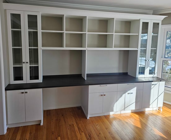 Custom Office and wall unit - has glass doors, and a matte blue countertop