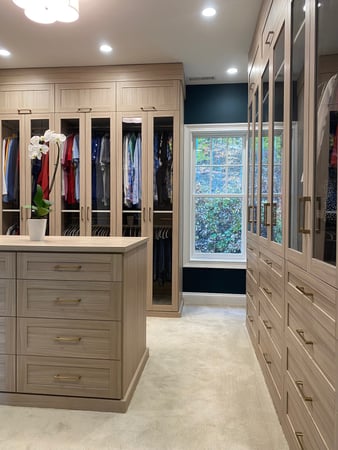Light wood finish walk-in closet with center island
