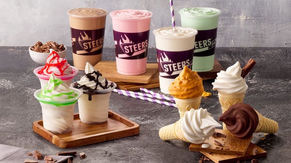 Various Steers® ice cream desserts on a granite surface. From milkshakes to ice cream cones and ice cream swirls in a cup.
