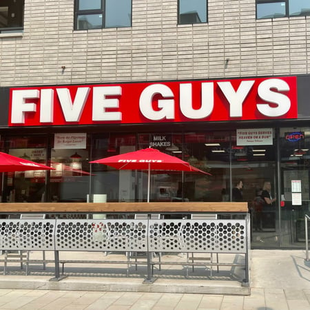 Store front of the Five Guys at 4112 University Ave NW in Calgary.