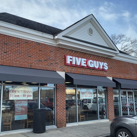 Exterior photograph of the Five Guys restaurant at 35 Merrick Road in Amityville, New York.
