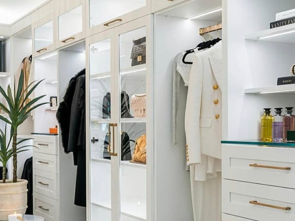 Luxury walk-in closet with custom hanging space, shelves, and drawers by California Closets Cleveland, Ohio.