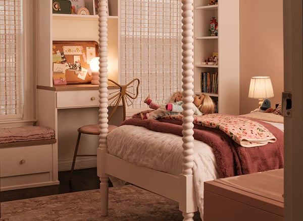 Custom kids' bedroom with built-in desk, window seat, shelving and storage cabinetry by California Closets Nashville.