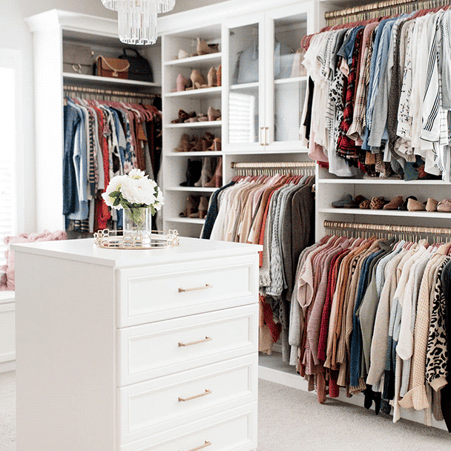 Luxe white walk-in closet with center island