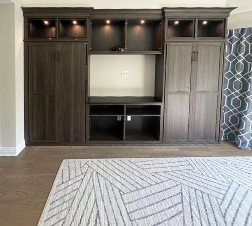 Built in closet cabinets and cubbies in dark wood grain finish created by California Closets Southern New jersey