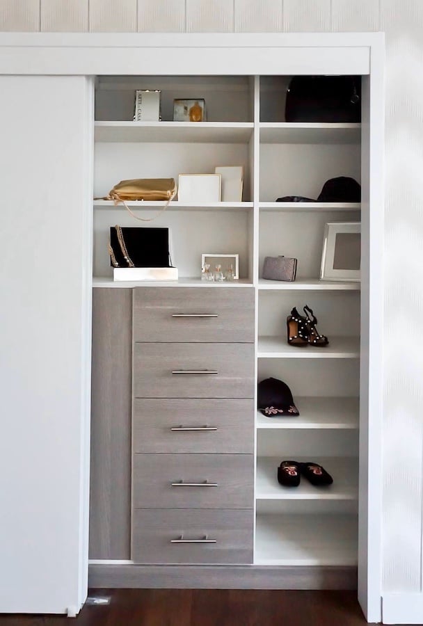 reach in closet with sliding doors, shelves and drawers