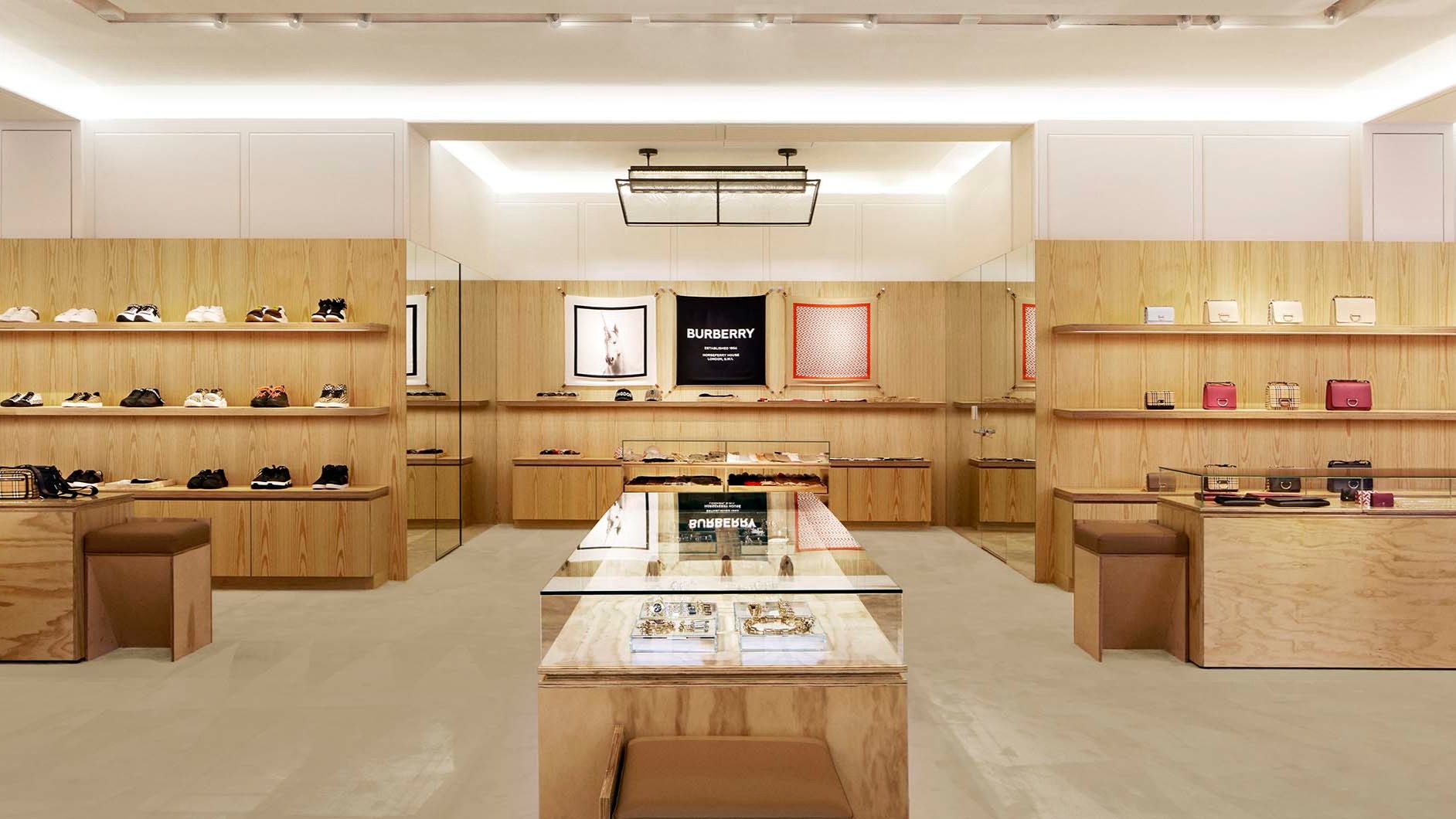 Burberry store close-up with shoes and bags on shelves.