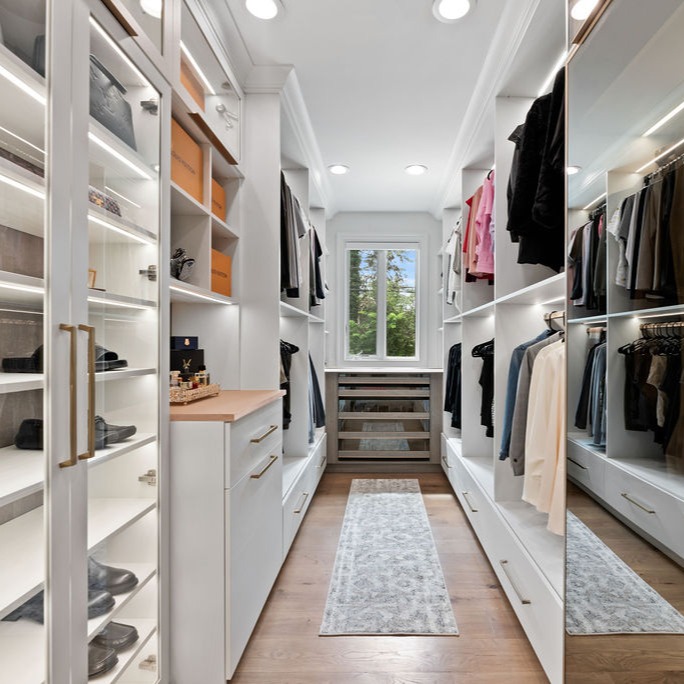 Custom walk in closet with Mirrored and glass doors