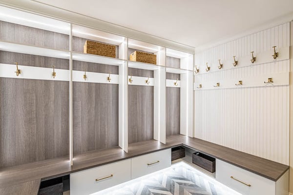 Large family mudroom with bench seating and lighting.