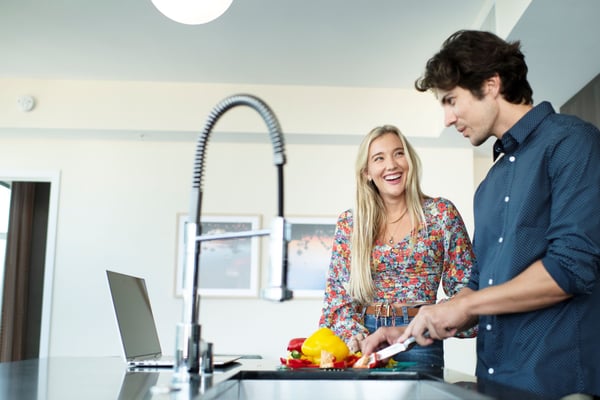 Couple streaming cooking show in kitchen