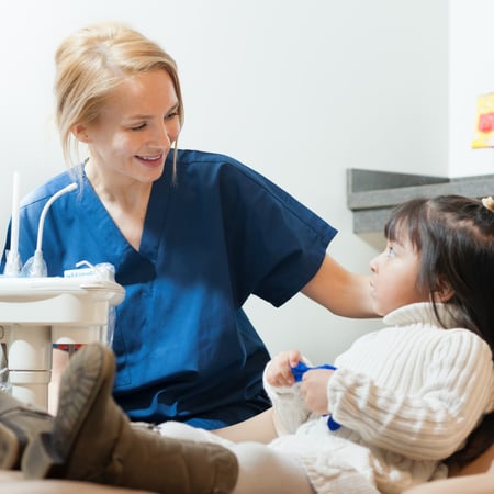 An Advantage Dental Dentist works with a young patient.