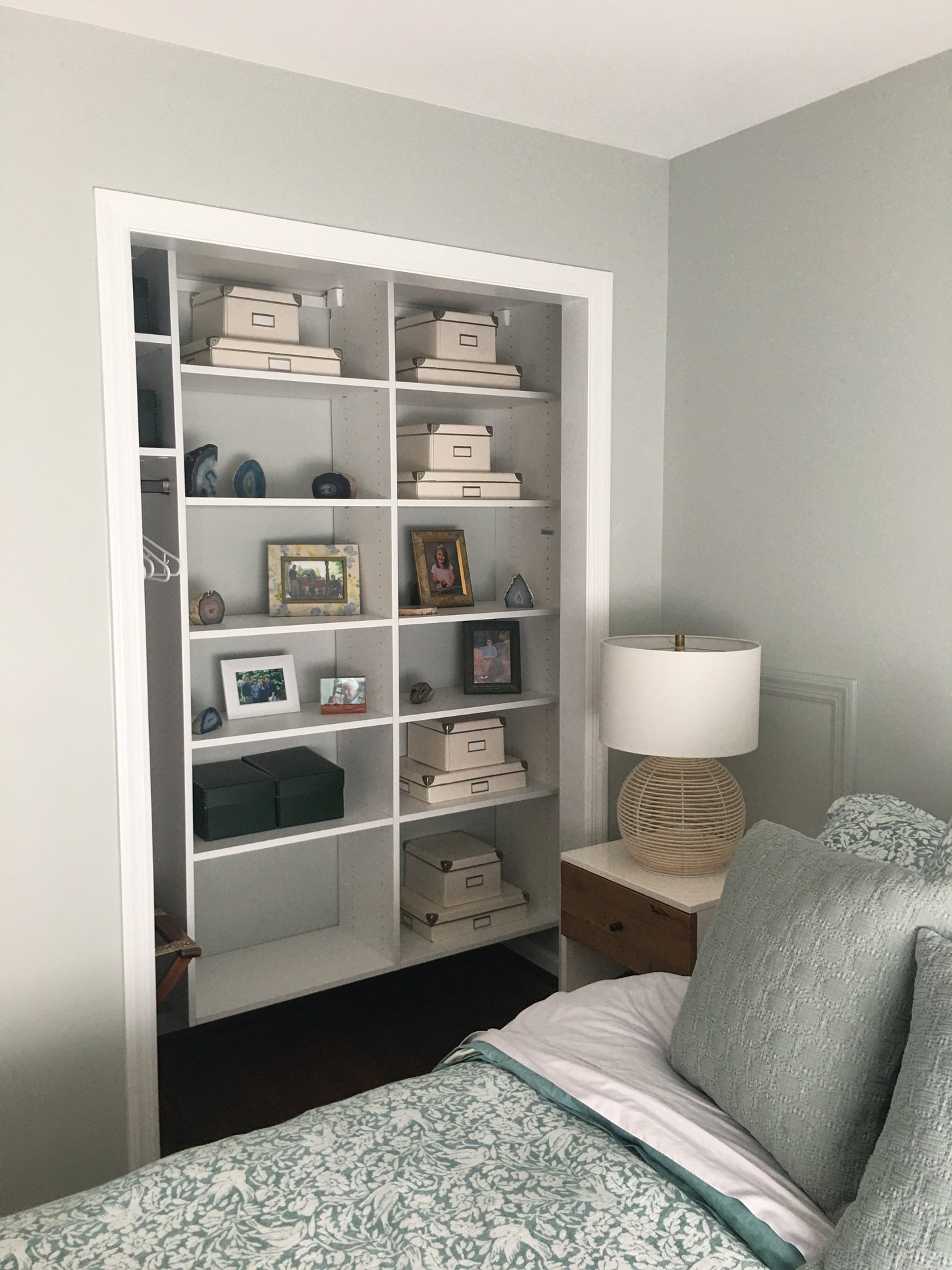 A custom reach in closet located in a guest bedroom with shelving by California Closets Pittsburgh in Pittsburgh Pennsylvania.