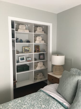 A custom reach in closet located in a guest bedroom with shelving by California Closets Pittsburgh in Pittsburgh Pennsylvania.