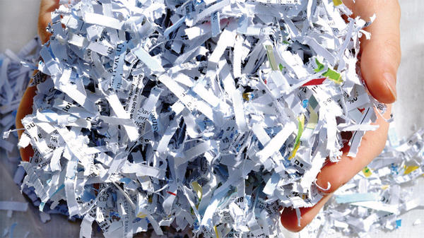 shredded paper in hands