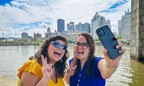 friends taking selfie at river