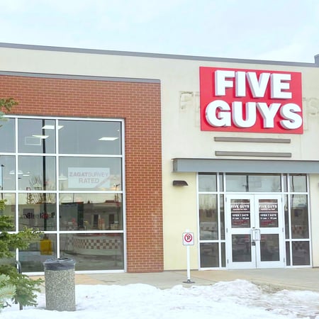 Photograph of the entrance to the Five Guys at 7337 Macleod Trail SE in Calgary, Alberta, Canada.