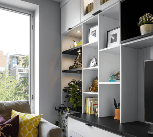 black & white media center with custom cubby shelving and LED puck lighting