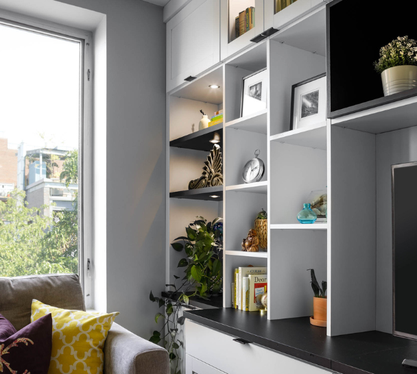 black & white media center with custom cubby shelving and LED puck lighting