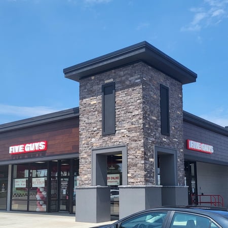 Exterior photograph of the entrance to the Five Guys restaurant at 1948 Ridge Road West in Greece, New York.
