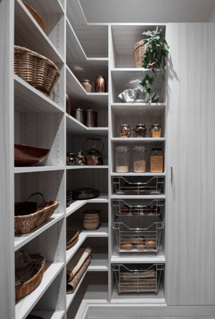 White Wood custom pantry with one closed cabinetry for brooms, and different sizing shelving for various pantry items Westchester NY