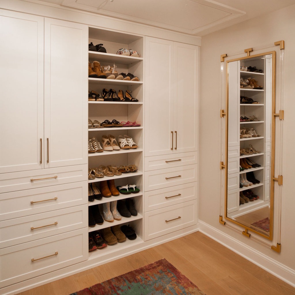 Sleek Built-in Wardrobe with Shoe Storage and Gold Hardware