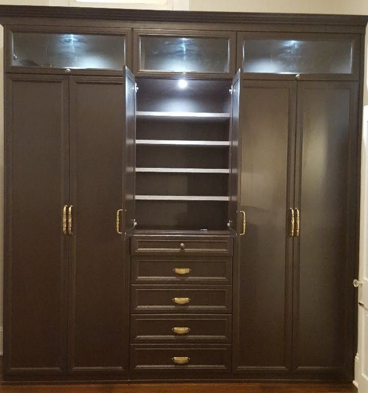 Brown wardrobe closet with drawers California Closets Pensacola and Panama City, Florida