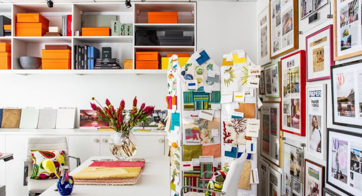 California Closets New York City Custom Commercial Space White Office Custom Bookshelves Storage Interior Design Studio with Closed Cabinets and two desk workspaces