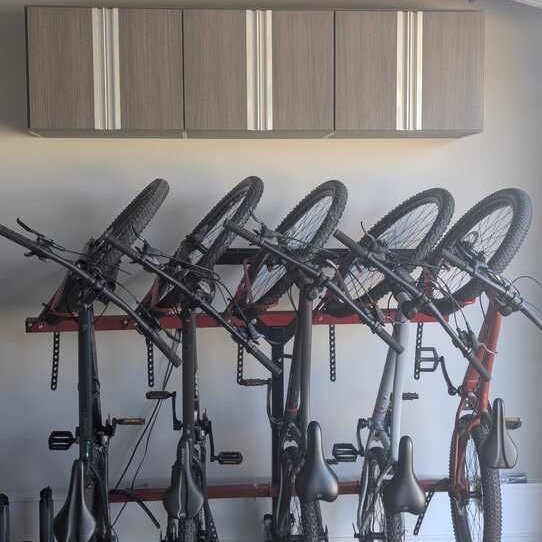 Richmond - Custom closets - storage system with overhead cabinets and wall-mounted bike racks holding multiple bicycles