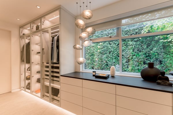 Modern walk in closet with clean slab drawer fronts