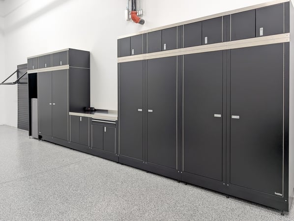 Custom garage storage system in black metal finish with black slat wall and tire rack.