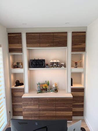 Floor to ceiling storage in a white finish with deep textured door fronts in a reddish brown colour.