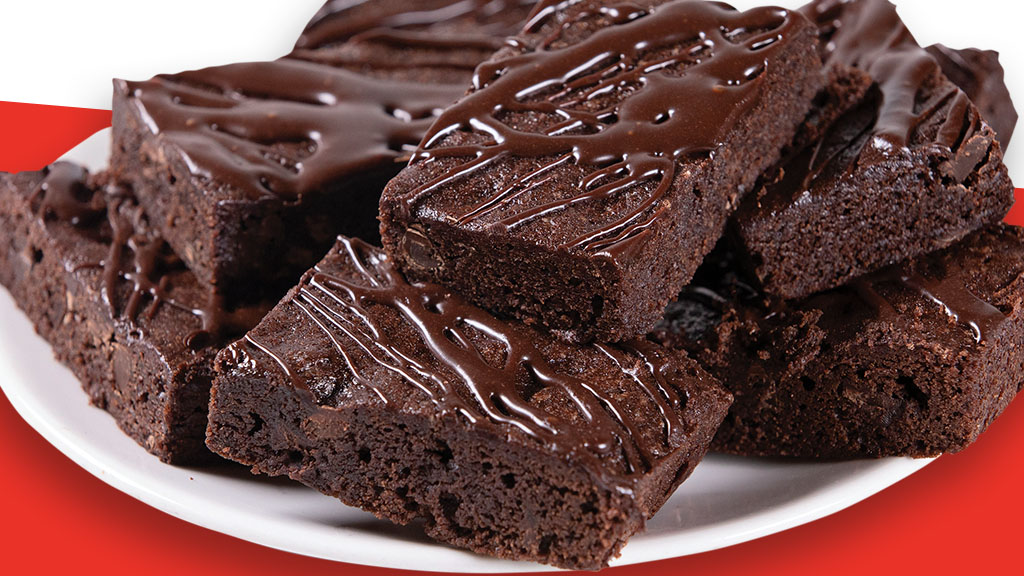 chocolate chips, chocolate chunks, and chocolate ganache surrounded by decadent fudge brownie