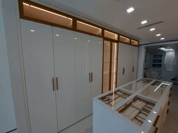 High Gloss doors, Aluminum framed cabinets with bronze glass and lights!