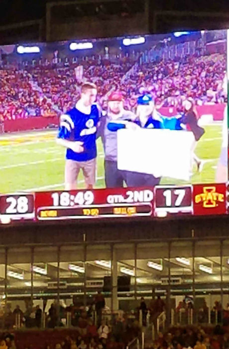 Allstate gives out check during half time showing Iowa State student support