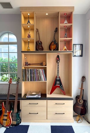 Custom guitar display cabinet with LED lighting for a teen room by California Closets in South Palm Beach, Florida, featuring luxury guitar storage and custom music room organization near Boca Raton.